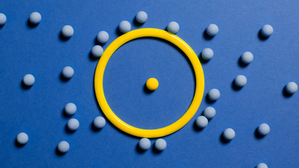 one-yellow-ball-in-ring-surrounded-by-blue-balls-1296x728-header-1024x575